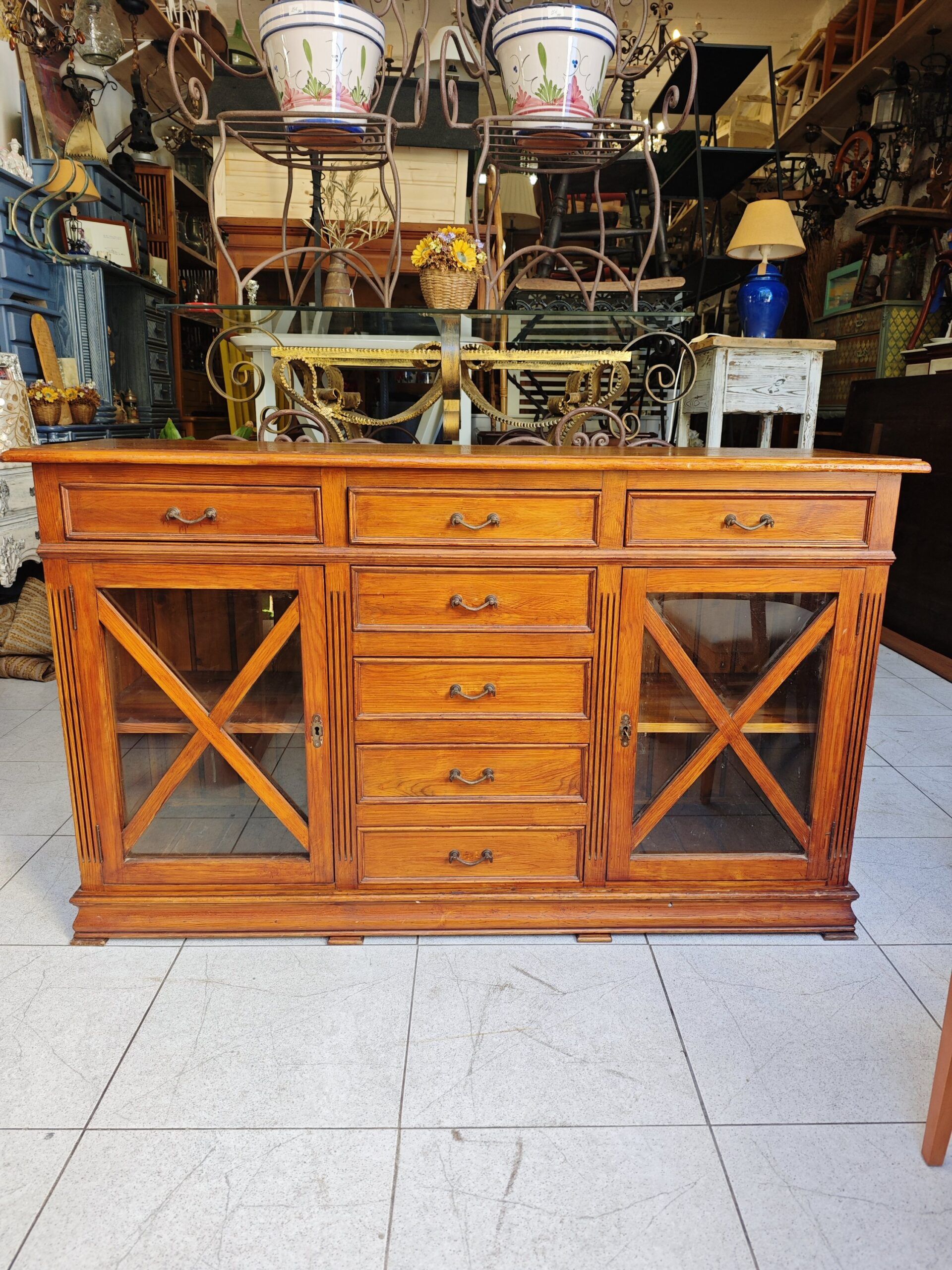 APARADOR RUSTICO PINO 1 Aparador rustico de pino macizo con vitrinas laterales y múltiples cajones.