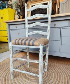 Solid Distressed Wood Chair with White Finish and Decorative Woven Seat.