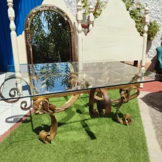 Gilded iron table with glass top.
